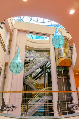 a building with a spiral staircase with blue lights at Howard Johnson Plaza by Wyndham Buenos Aires Florida Street in Buenos Aires