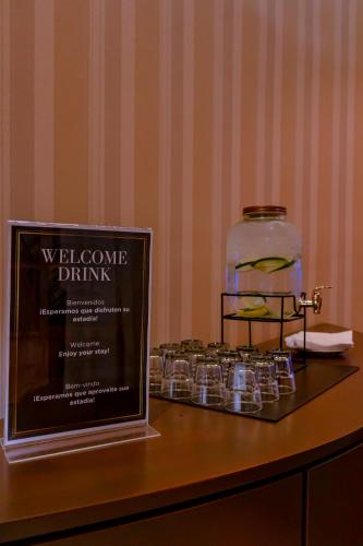 a display of glasses and a bottle on a table at Howard Johnson Plaza by Wyndham Buenos Aires Florida Street in Buenos Aires