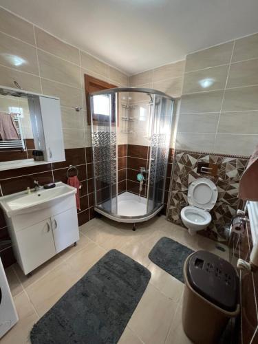 a bathroom with a shower and a toilet and a sink at İnci Sitesi in Tekirdag