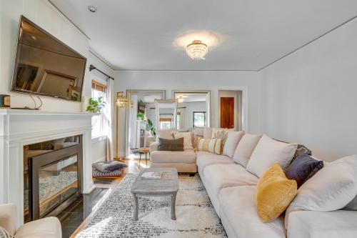 a living room with a couch and a fireplace at Charming Louisville Retreat with Patio and Fireplace! in Louisville