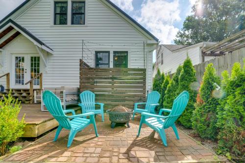 a patio with four chairs and a table at Charming Louisville Retreat with Patio and Fireplace! in Louisville