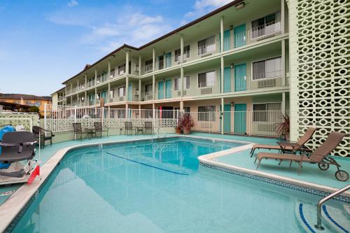 a swimming pool in front of a building with a hotel at The Stevenson Monterey in Monterey