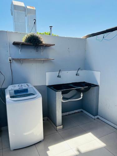 a bathroom with a sink and a trash can at Hostel Meio do Mundo in Macapá