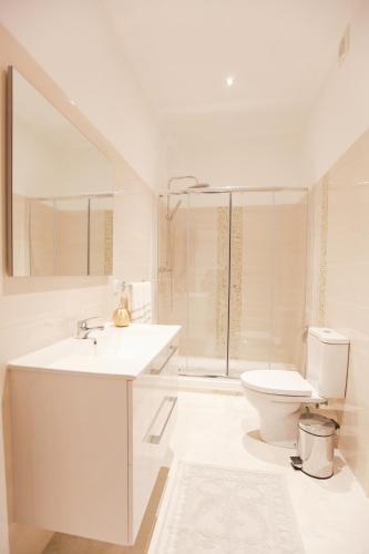 a bathroom with a toilet and a sink and a shower at Glamorous Apartment Park Ed VII in Lisbon