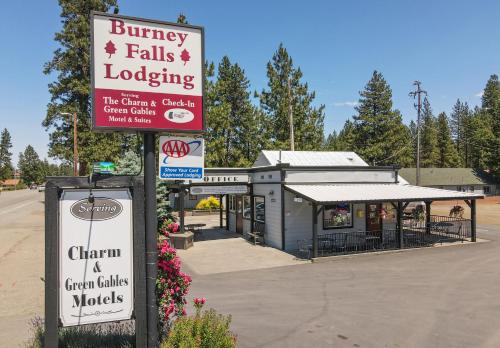 a building with a sign for a bunaky falls lodge at Charm Motel & Suites in Burney