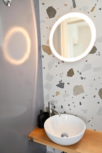 a bathroom with a sink and a mirror at Mimosa e Agave Blu in Scicli