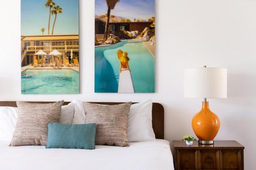 a bedroom with a bed with three pictures on the wall at Del Marcos Hotel, A Kirkwood Collection Hotel in Palm Springs