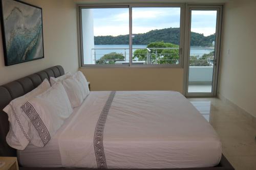 Un pat sau paturi într-o cameră la 6E Floor to Ceiling Oceanview Resort Panama