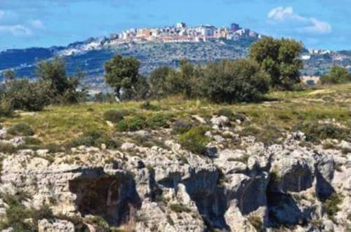 a rocky hill with a city on top of it at DIMORA STORICA ALLA ROTONDA in Mottola