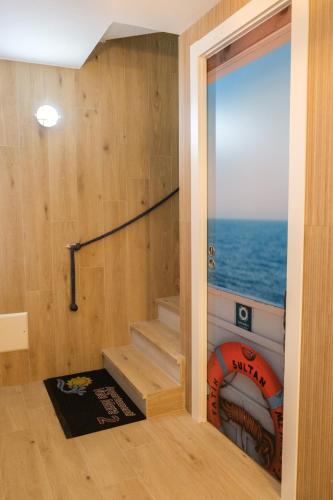 a room with a staircase with a view of the ocean at Appartamenti Vale Mare 2 in Chioggia