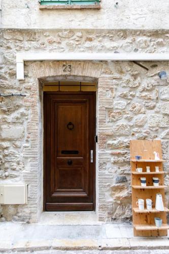 a door of a stone building with a wooden door at Appartements climatisés - Vieil Antibes in Antibes