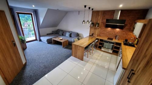 an overhead view of a living room and kitchen with a couch at Willa Kania in Szczawnica