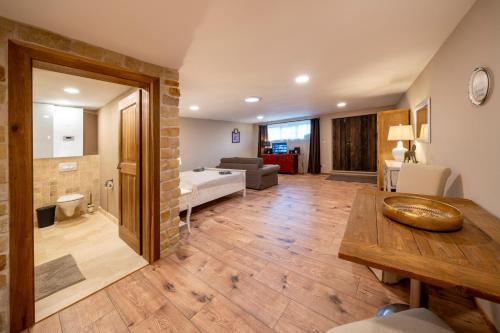 a large living room with a table and a couch at Prague West - Studio Chyne Terrace in Chýně