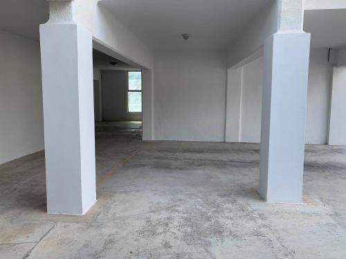 an empty room with white pillars in a building at Mar de Moravit by Nora Nice in Moraira