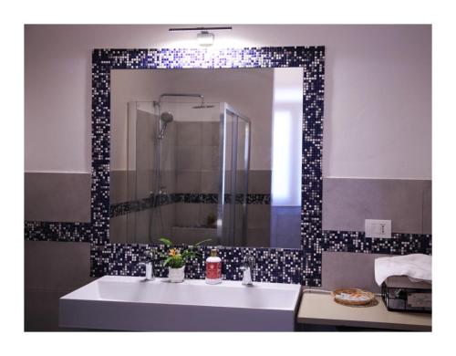 a bathroom with a white sink and a mirror at Casa Vacanze Piazza Padella in San Severino Marche