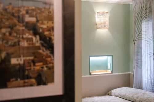a room with a window and a picture of a city at Appartamenti Vale Mare 2 in Chioggia