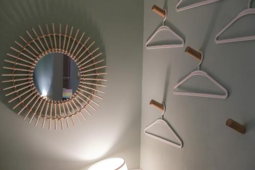 a bathroom with a mirror and a white wall at Appartamenti Vale Mare 2 in Chioggia
