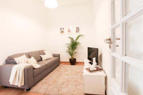 a living room with a couch and a table at Glamorous Apartment Park Ed VII in Lisbon