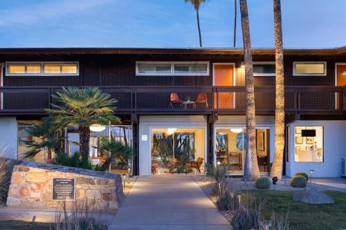 a house with palm trees in front of it at Del Marcos Hotel in Palm Springs