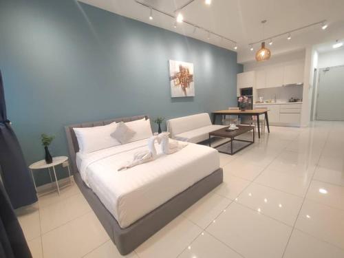 a bedroom with a bed and a living room at Chambers Suites KL - by Staycation Homes in Kuala Lumpur