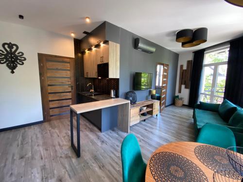 a living room with a couch and a table at Apartamenty ZakopanePoleca - Krupówki Centrum in Zakopane