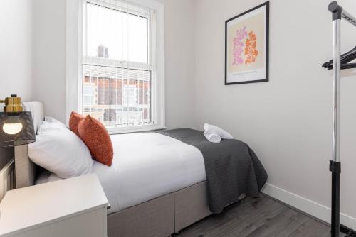 a white bedroom with a bed and a window at Host Liverpool - Stadium Side by Anfield, family home from home in Liverpool