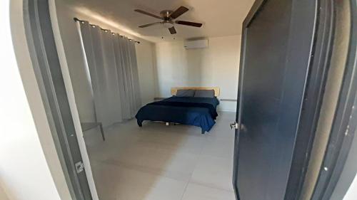 a bedroom with a bed and a ceiling fan at New Town Condo Casamar 3 near the beach in Puerto Peñasco