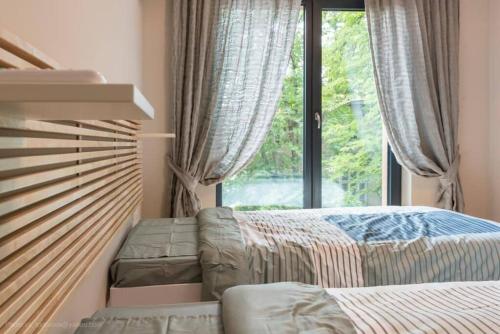 ein Schlafzimmer mit einem Bett und einem großen Fenster in der Unterkunft Around the globe apartment in Warna