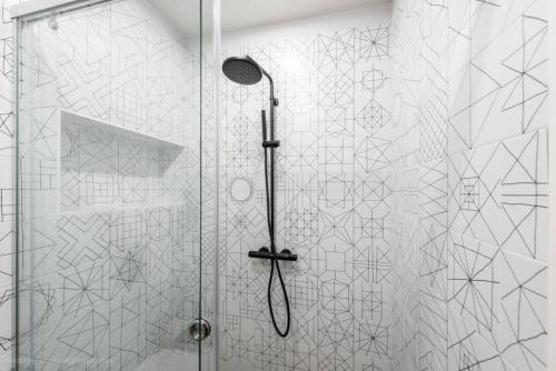 a shower with a glass door in a bathroom at Around the globe apartment in Varna City