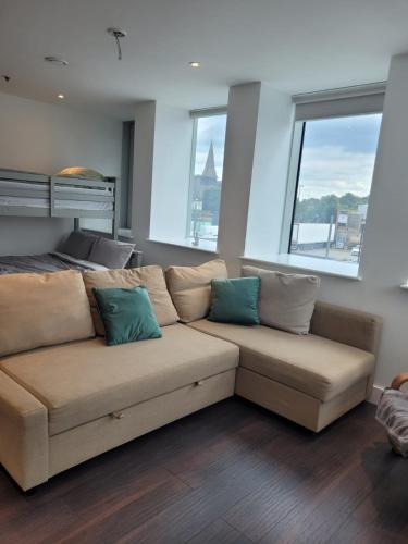 a living room with a couch with two pillows on it at 2BR Chic London Sleep 9 BP7 in London