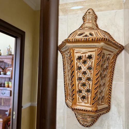 a decorative object is hanging on a wall at The Old Fashioned House in Pizzo