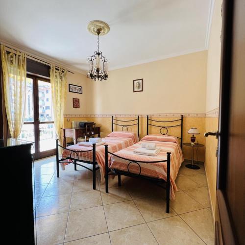 a bedroom with two beds and a table at The Old Fashioned House in Pizzo