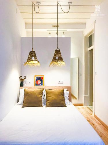 a bedroom with a large white bed with two pillows at Beach & Castle - Sines Apartment in Sines