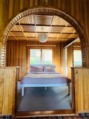 a bed in a room with an arched ceiling at Siedlisko pod Tatrami - agroturystyka in Maruszyna