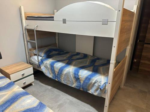two bunk beds in a small room with a bed at Bahçe katı 2+1,denize sıfır site in Bodrum City