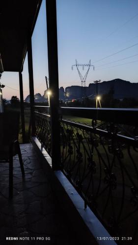 a balcony with a fence and a view of a train at Meteora countryside villa in Kalabaka