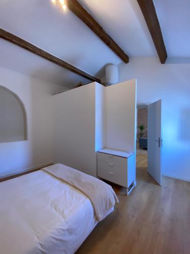 ein weißes Schlafzimmer mit einem Bett und einem Schrank in der Unterkunft Casa do Calvário in Évora