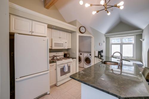 a kitchen with a white refrigerator and a sink at Jackson Lakefront Getaway with Balcony, Dock Access in Jackson