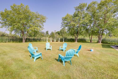 a group of blue chairs sitting in the grass at Jackson Lakefront Getaway with Balcony, Dock Access in Jackson