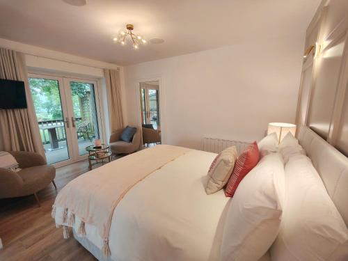 a bedroom with a large white bed with pillows at The View at Moneylands in Arklow