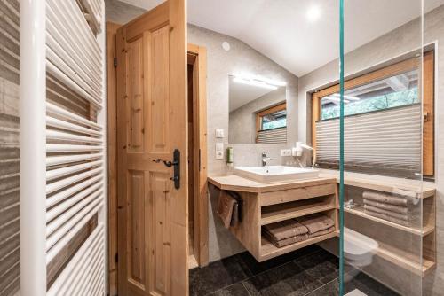 a bathroom with a sink and a mirror at Holzknechthütte in Mayrhofen