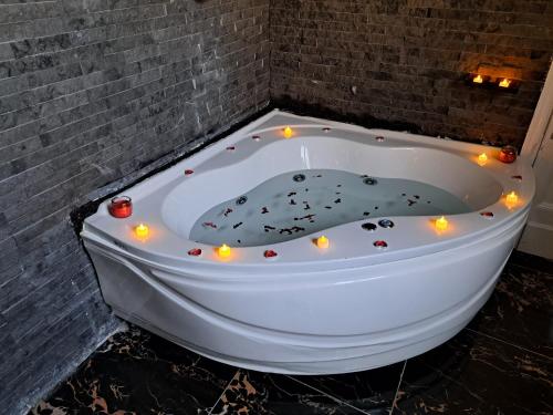 a bathtub decorated with lights in a bathroom at downtown Family Suites in Cairo