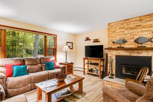a living room with a couch and a fireplace at Northwoods Paradise in Eagle River