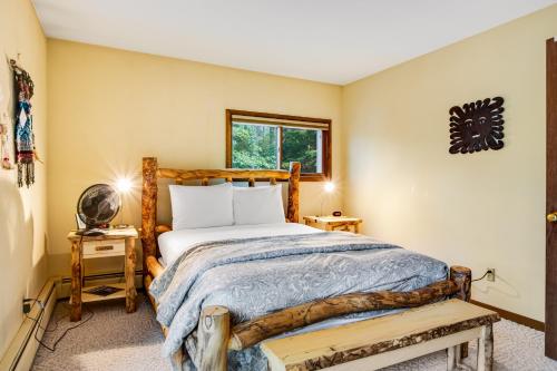 a bedroom with a wooden bed and a window at Northwoods Paradise in Eagle River