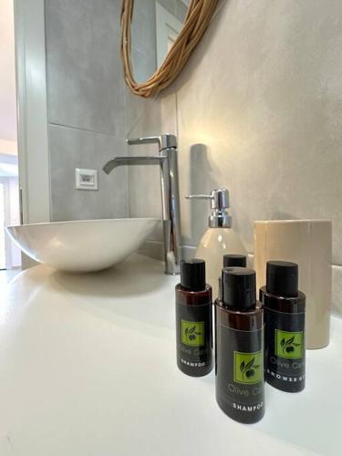 a bathroom with two bottles on a counter next to a sink at Moma Apartment in Kithnos