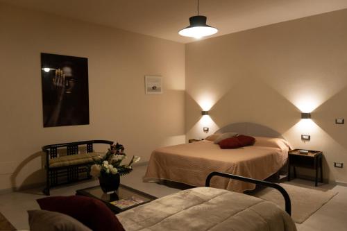 a hotel room with two beds and a couch at Tenuta I Gelsi in Benevento