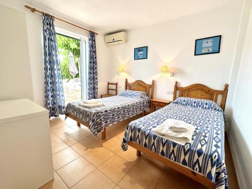 a room with two beds and a window at Villa Ana R9 in Santo Tomás