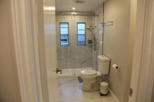 a bathroom with a toilet and a glass shower at Waterfront Paradise in Sooke