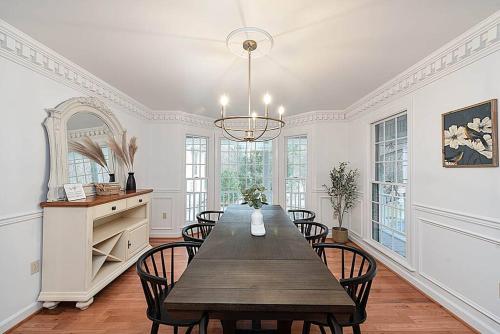a dining room with a wooden table and chairs at Jackson River Estate 3 dwellings on River w/ Pool sleeps 23 in Covington