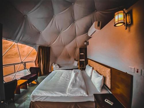 a bedroom with a large bed in a tent at Star rum in Wadi Rum